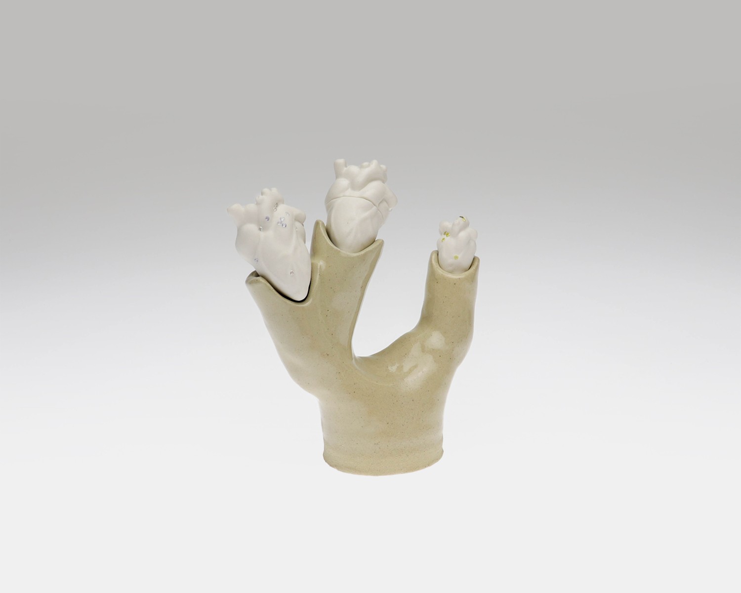 Individual view of a unique ceramic heart from Perfect Imperfection series by Yuxin Song. Highlighting cracks with cubic zirconia and mica powder. Light-up sculpture made with resin, 2022.