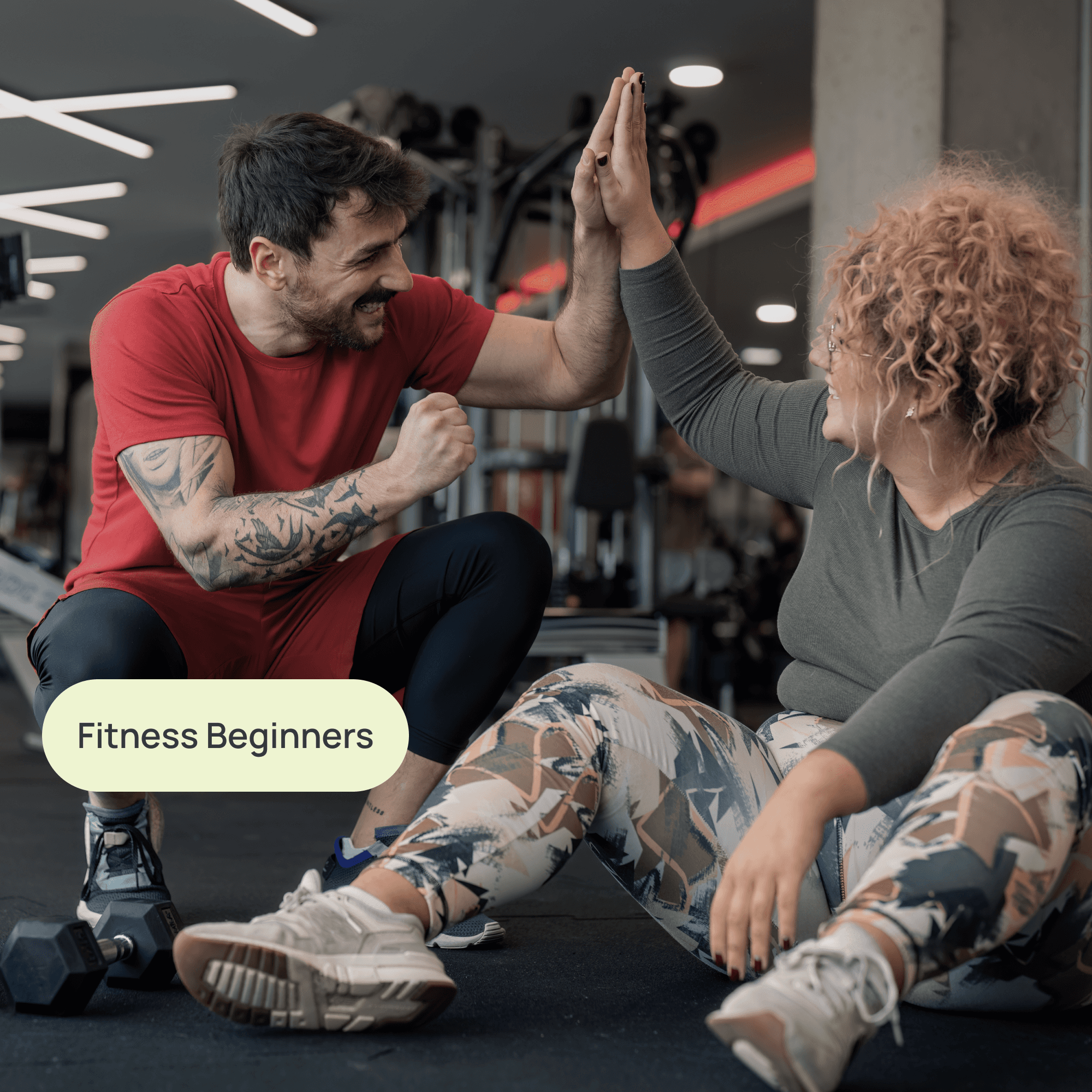 woman high fiving her trainer at the gym with label "fitness beginners"