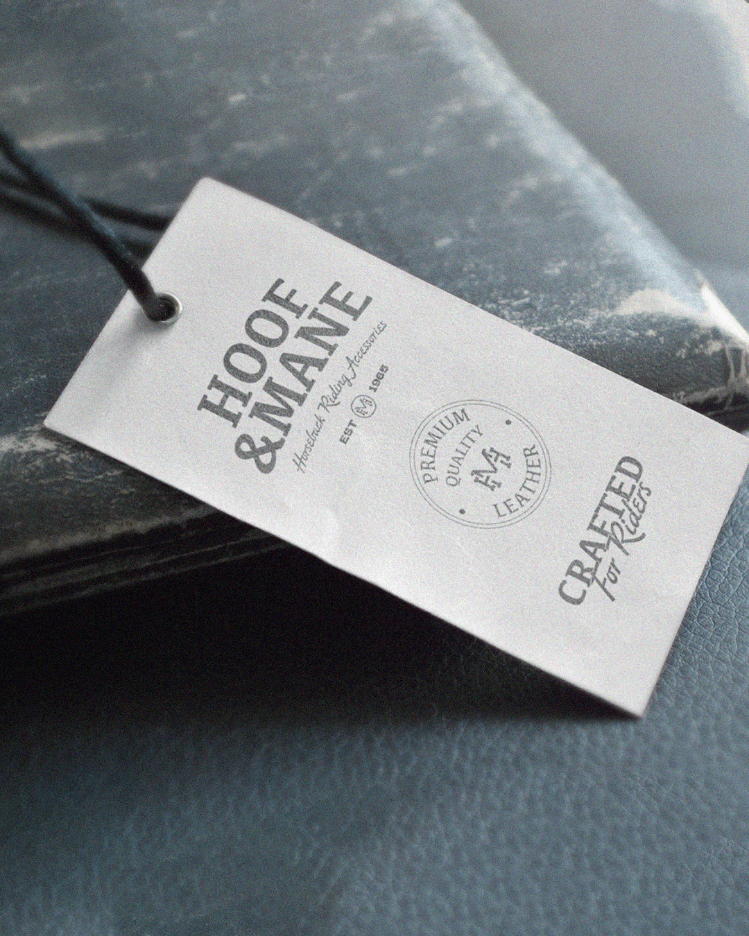 Black bucket hat floating against black, embroidered at the front with the distressed white Deadpan smiley face logo (X eyes, tongue out).