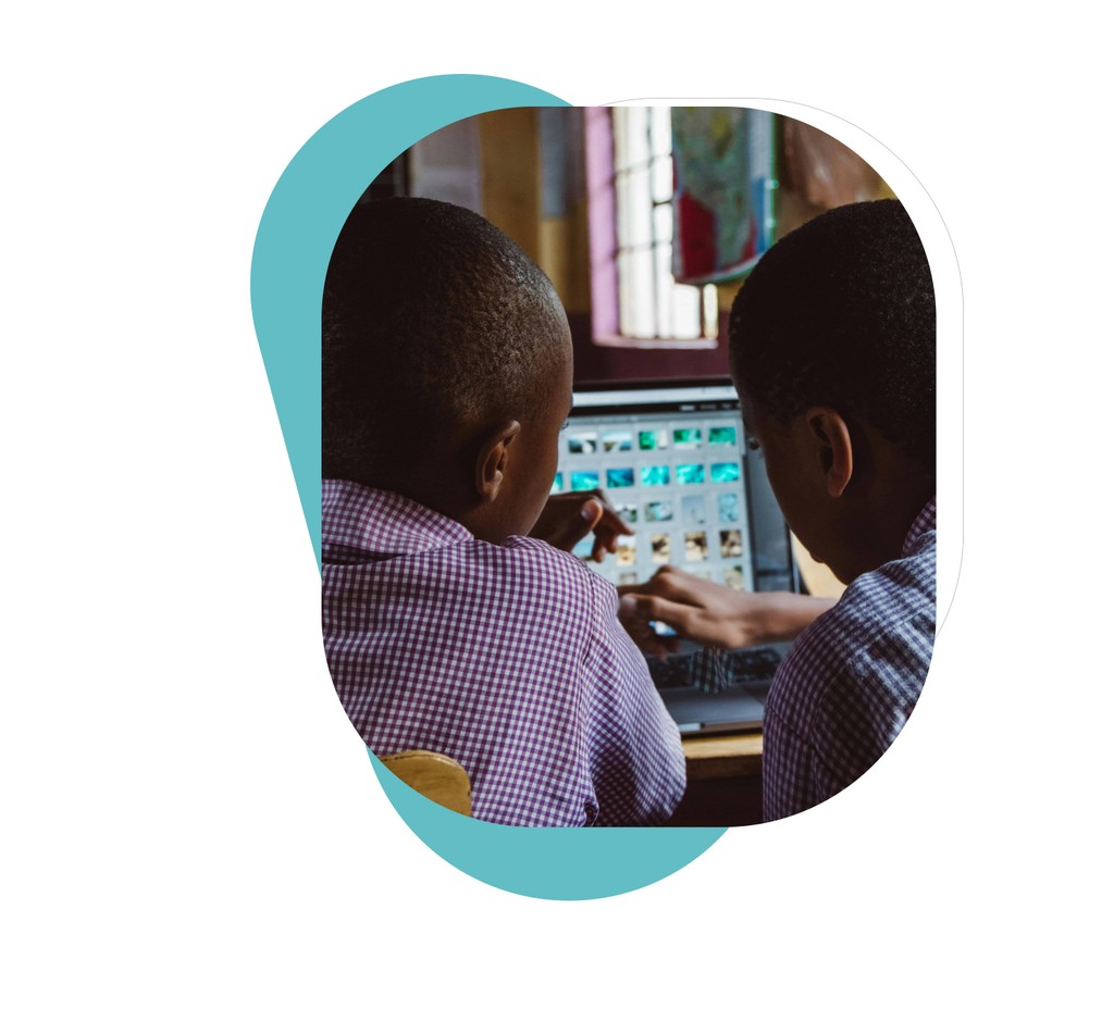 Two young boys using laptop, learning digital skills