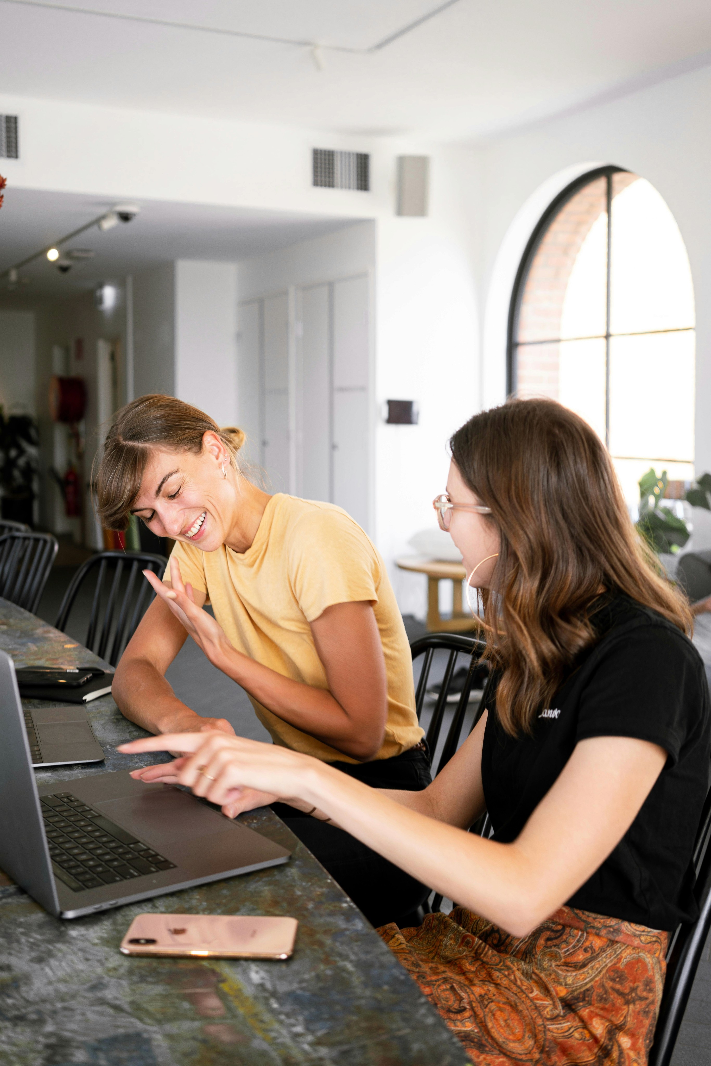 Two women laughing at work