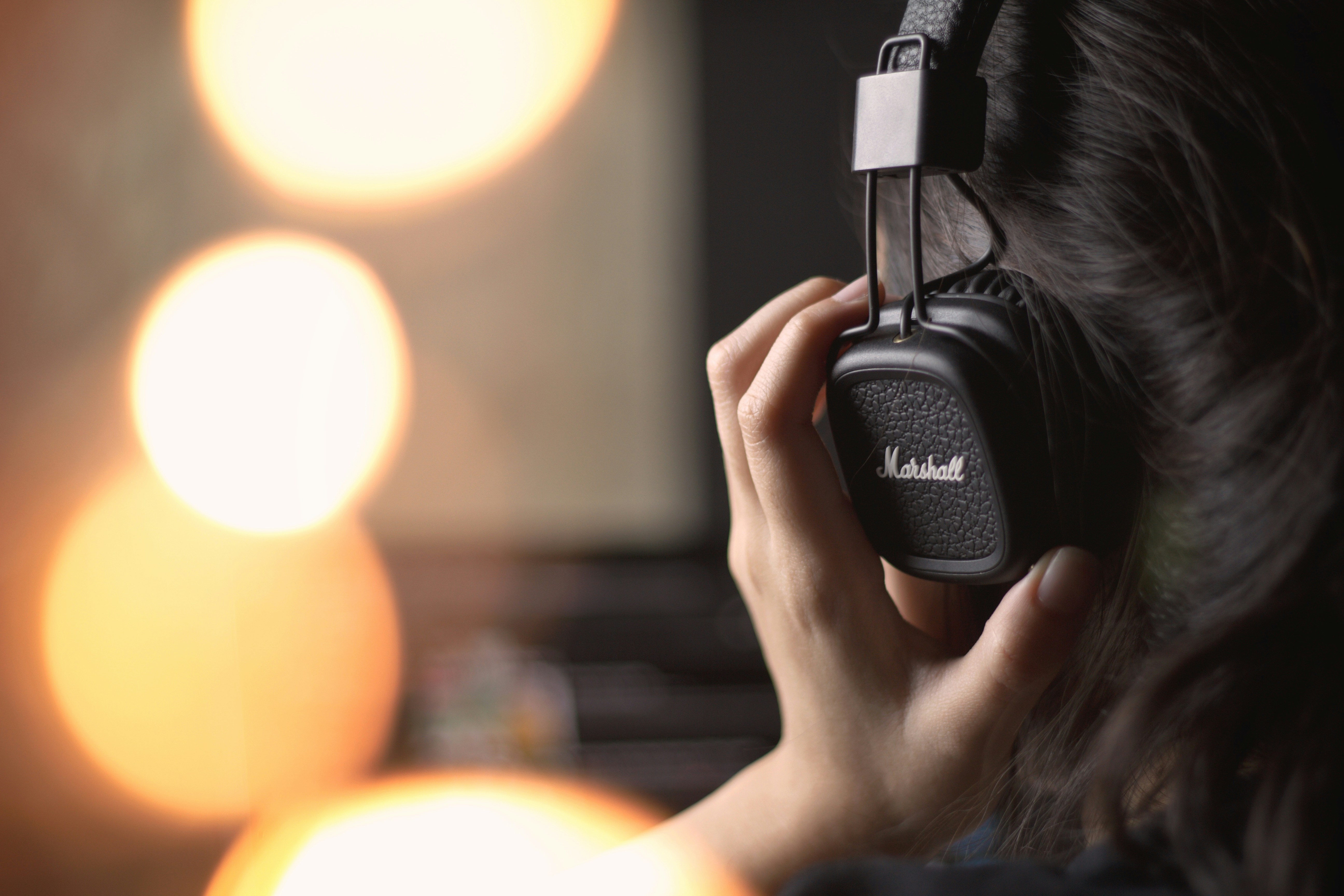 woman testing out Best headphones for music production