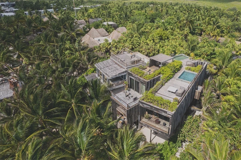 Aerial view of Be Tulum hotel, featuring private pools, rooftops, and surrounded by lush jungle.