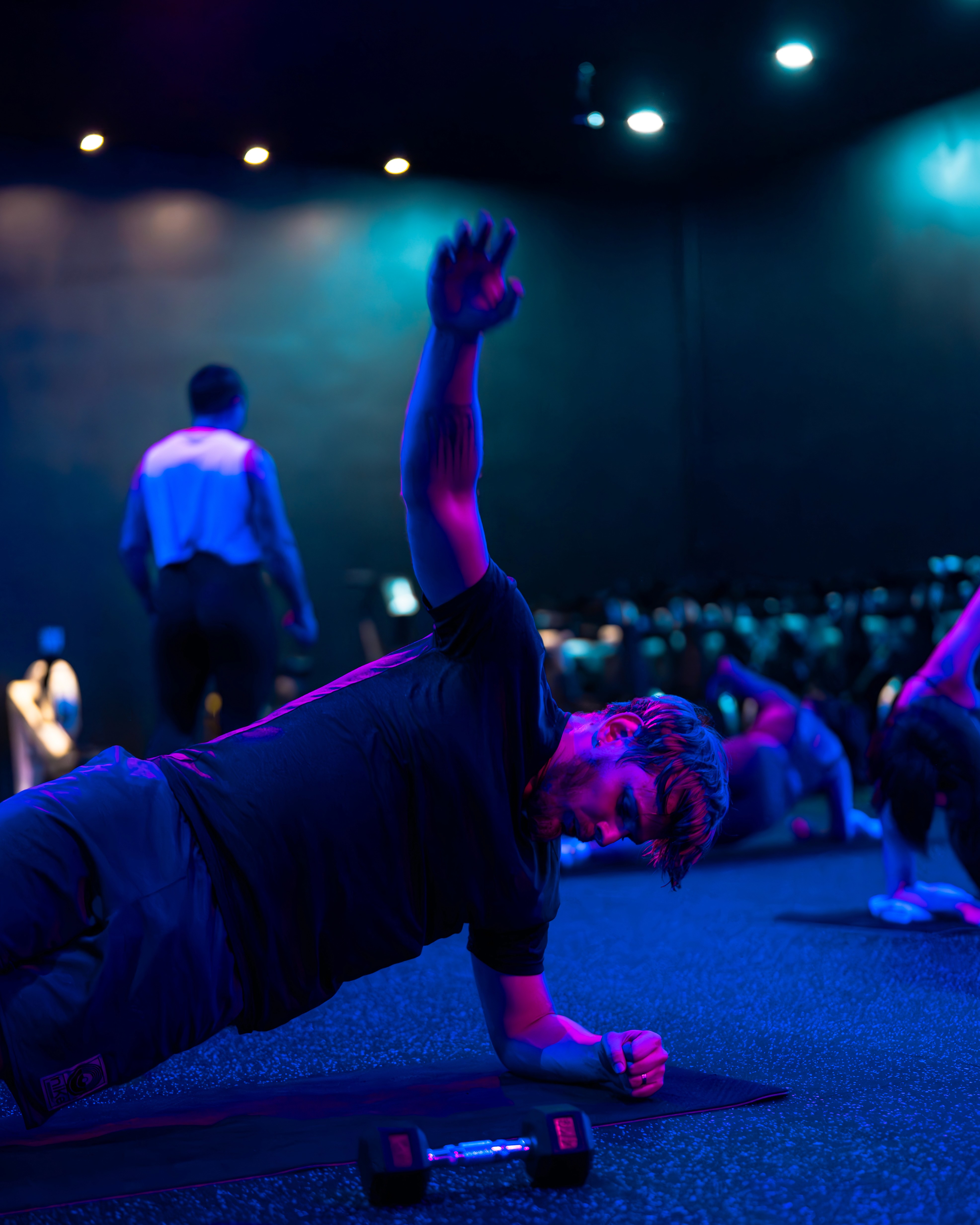 Energetic Zumba Aerobics group class at Legacy Muscle Universe Koh Samui, featuring dance fitness in a neon-lit Blue Neo Studio.