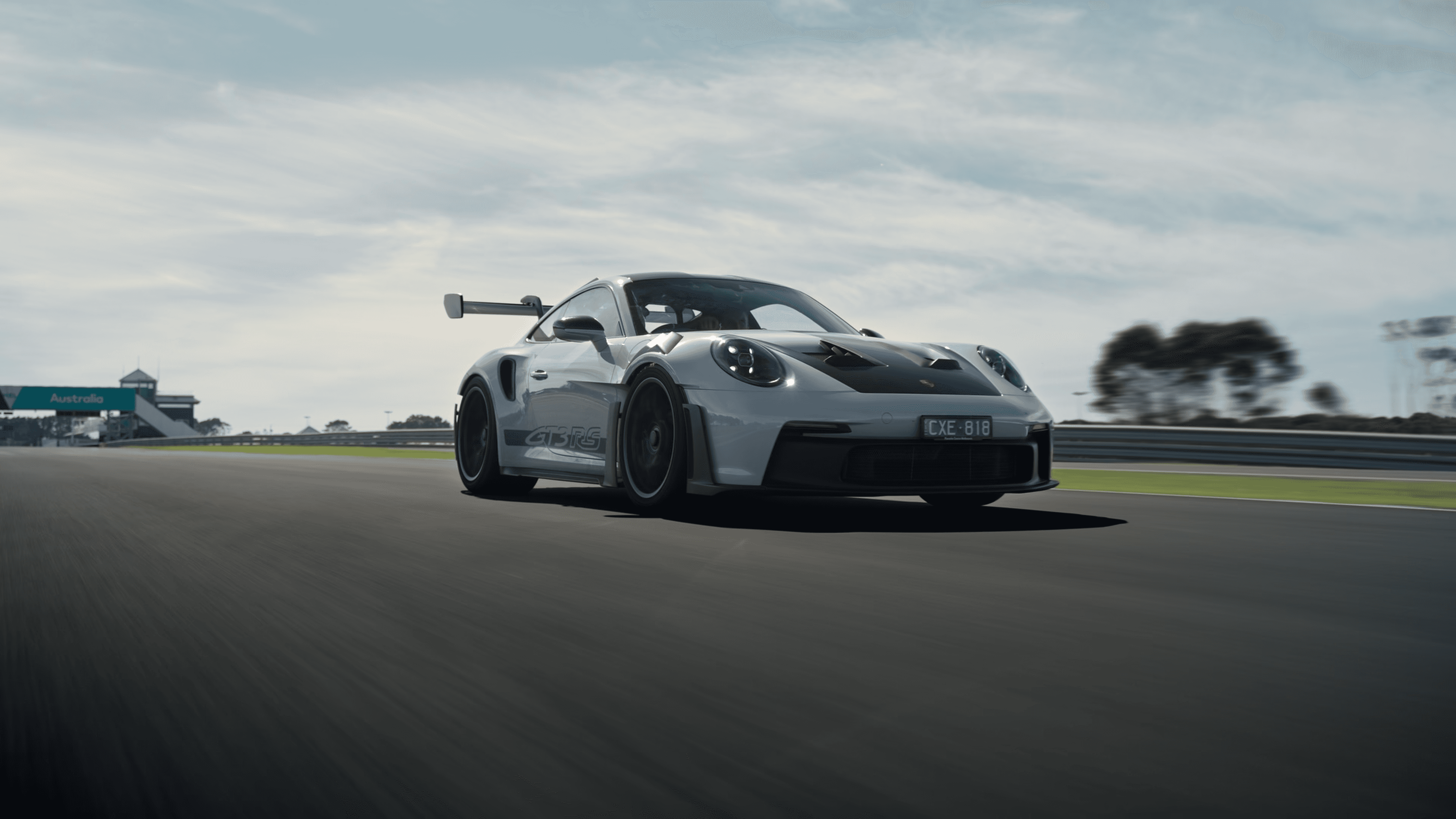 A model standing confidently in a park, with tall buildings and the city's skyline visible behind her