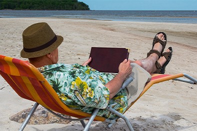 Close-up of lush, dark green leaves, some glossy and wet, against a muted background.