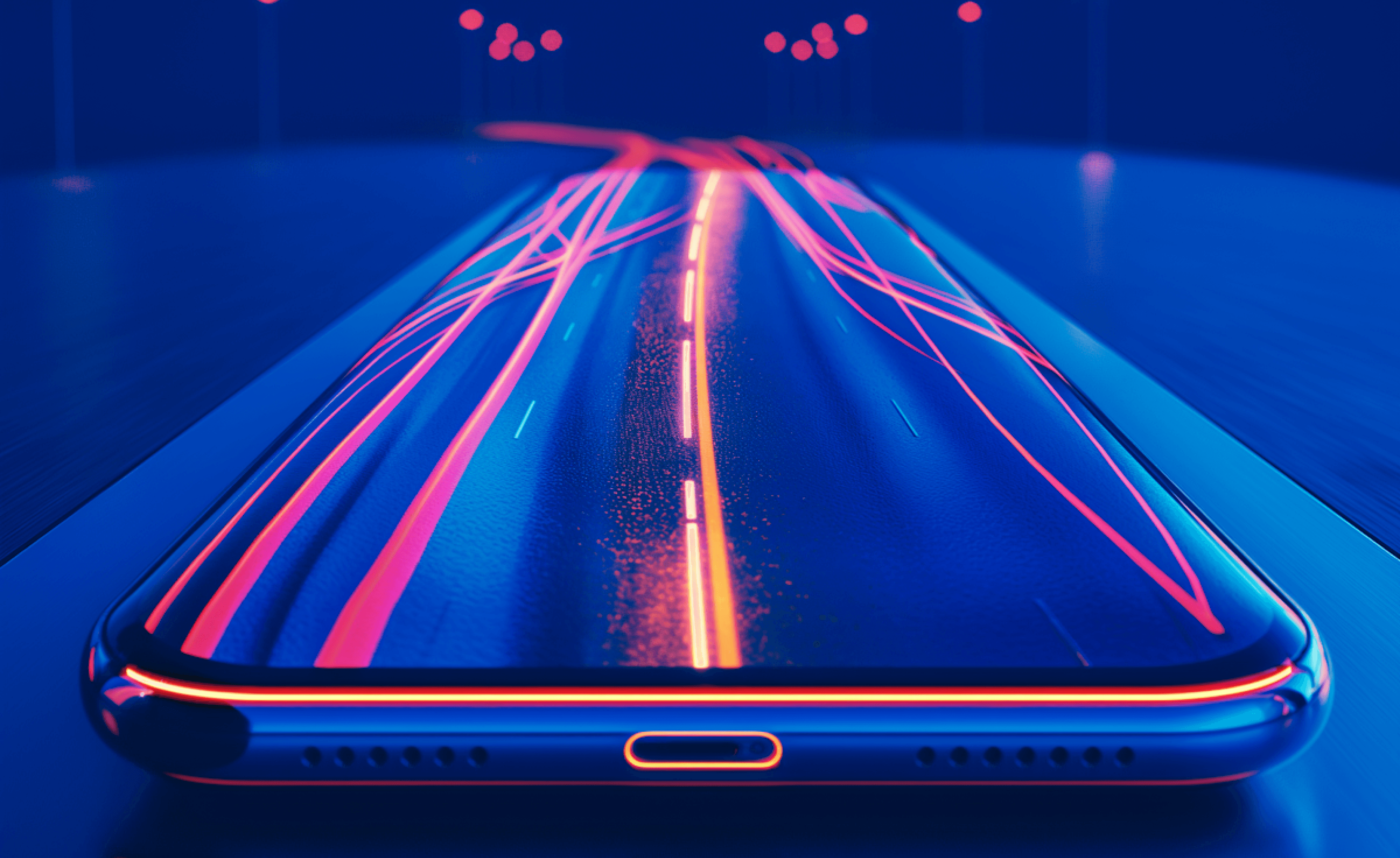 Smartphone on a surface displaying a neon road scene that extends into the background