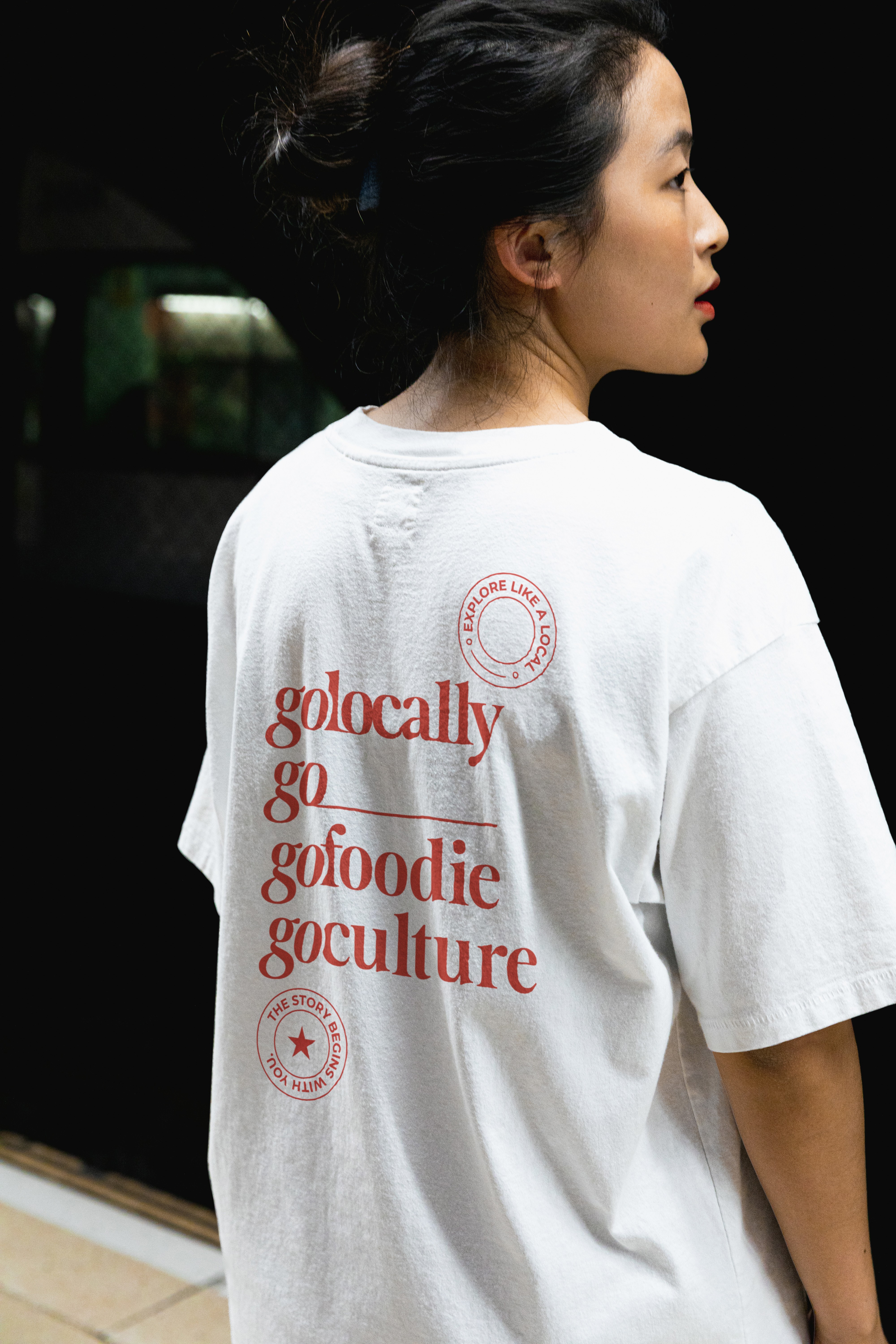 woman sitting around table holding tablet