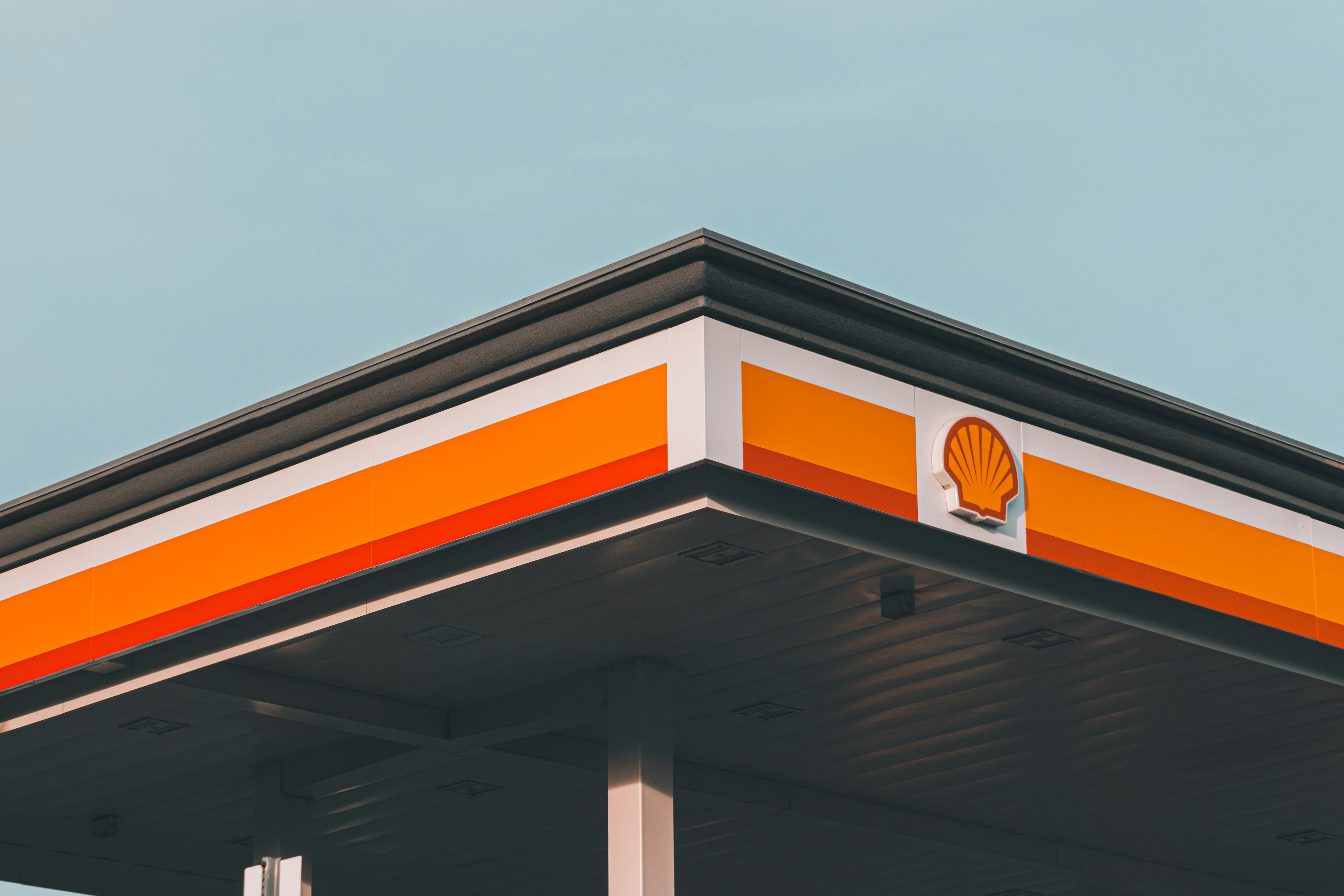 a shell gas station with a sky background