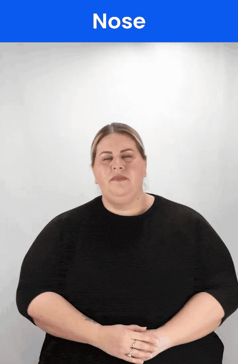 Animated GIF: a Deaf signer signs NOSE in ASL, the index fingertip touching the side of the nose.