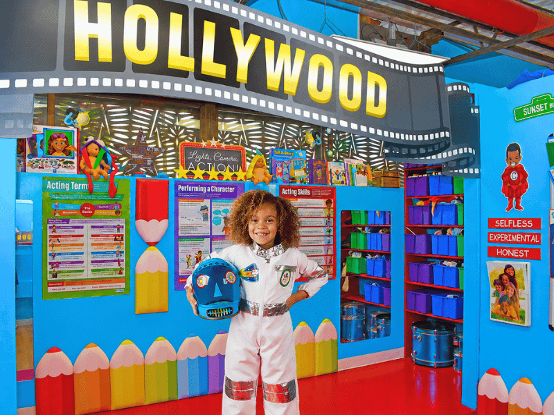 Preschool student dressed as an astronaut standing on the Hollywood dramatic play stage at Little Adventures Academy in Scottsdale.
