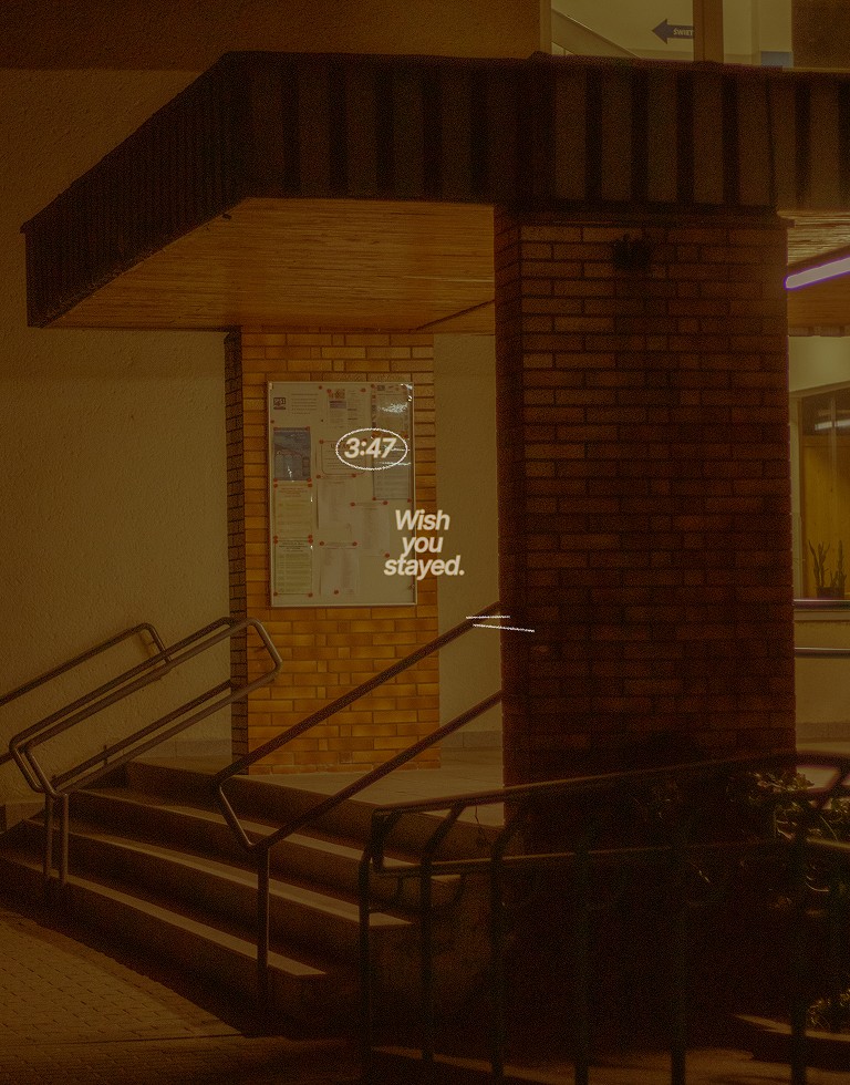 A close-up of a pink cocktail in a martini glass, set against a nighttime background with soft, blurred colors.