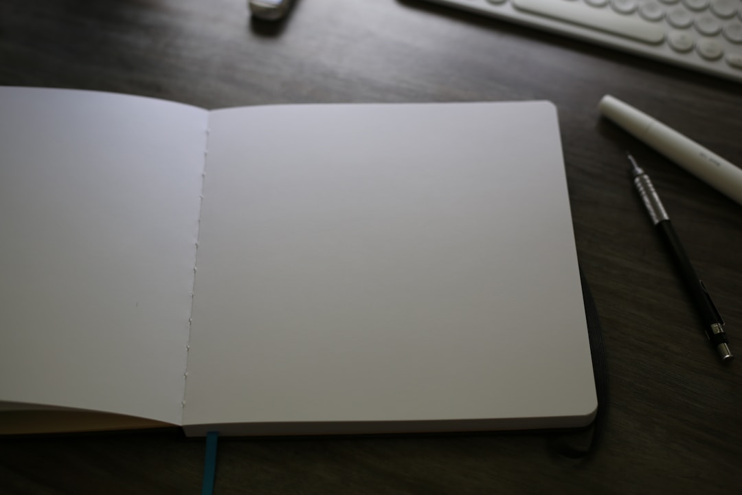 designer sketching wireframe on paper notebook