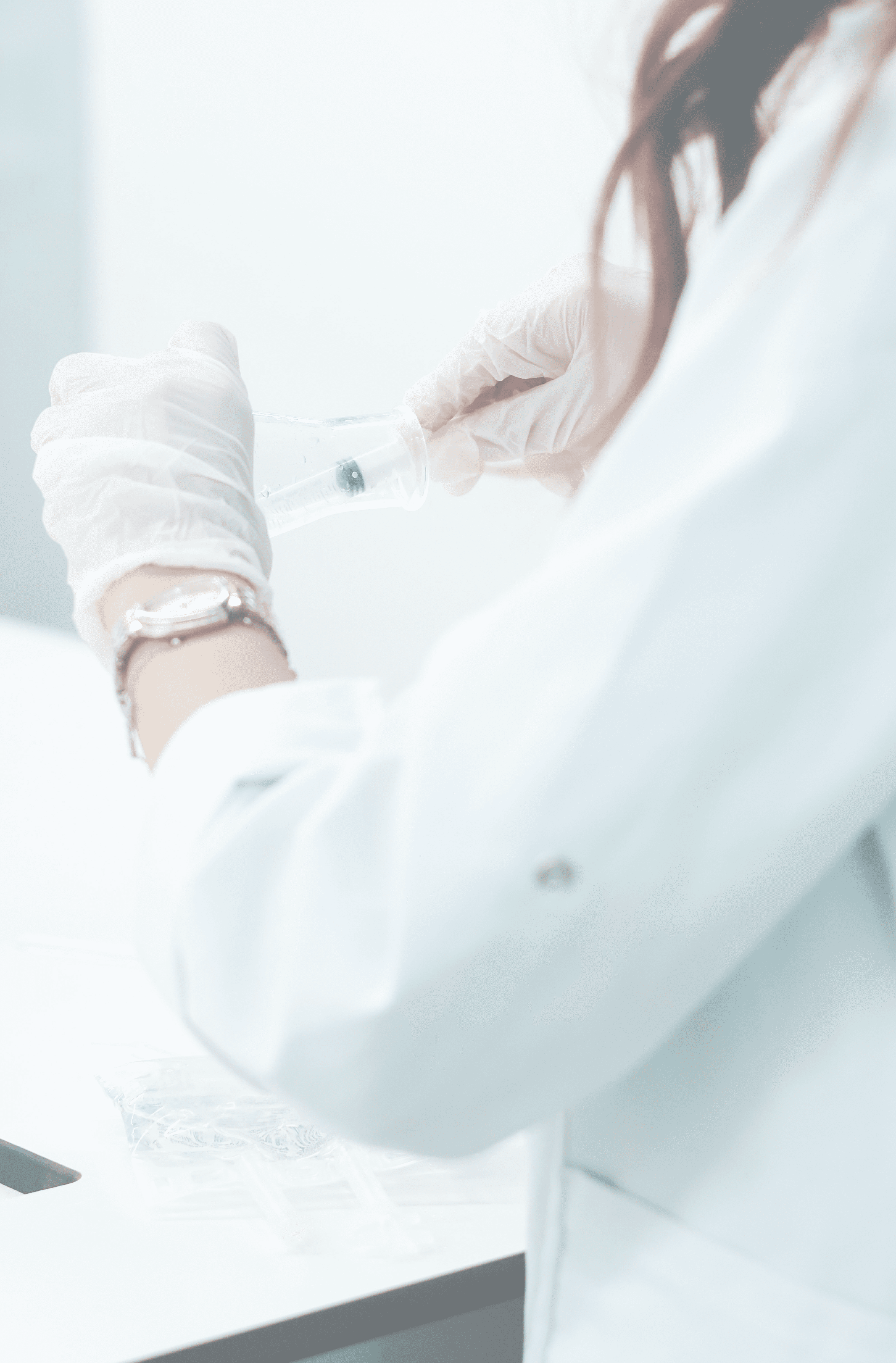 Scientist in lab coat prepares medical sample.