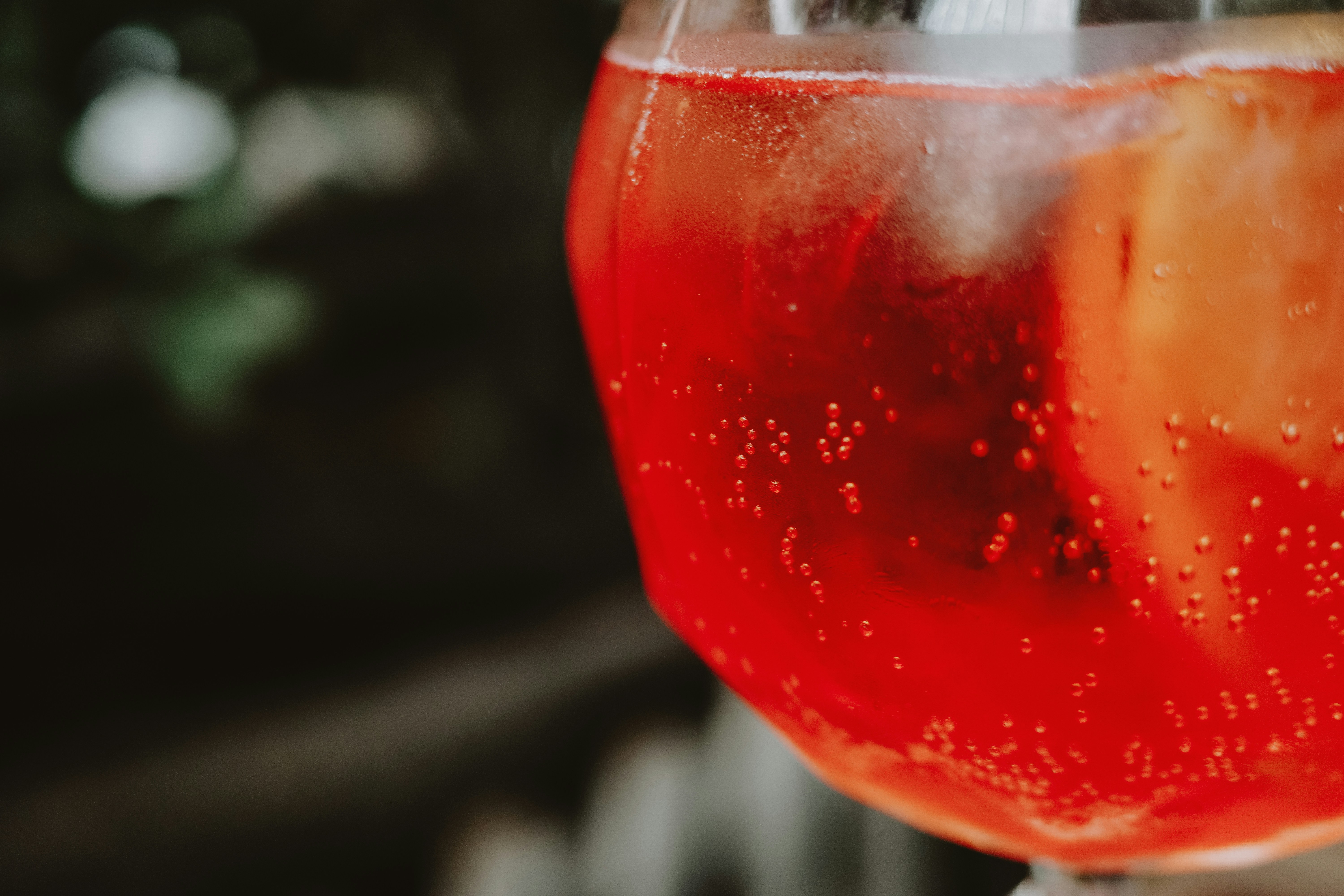 four boys laughing and sitting on grass during daytime