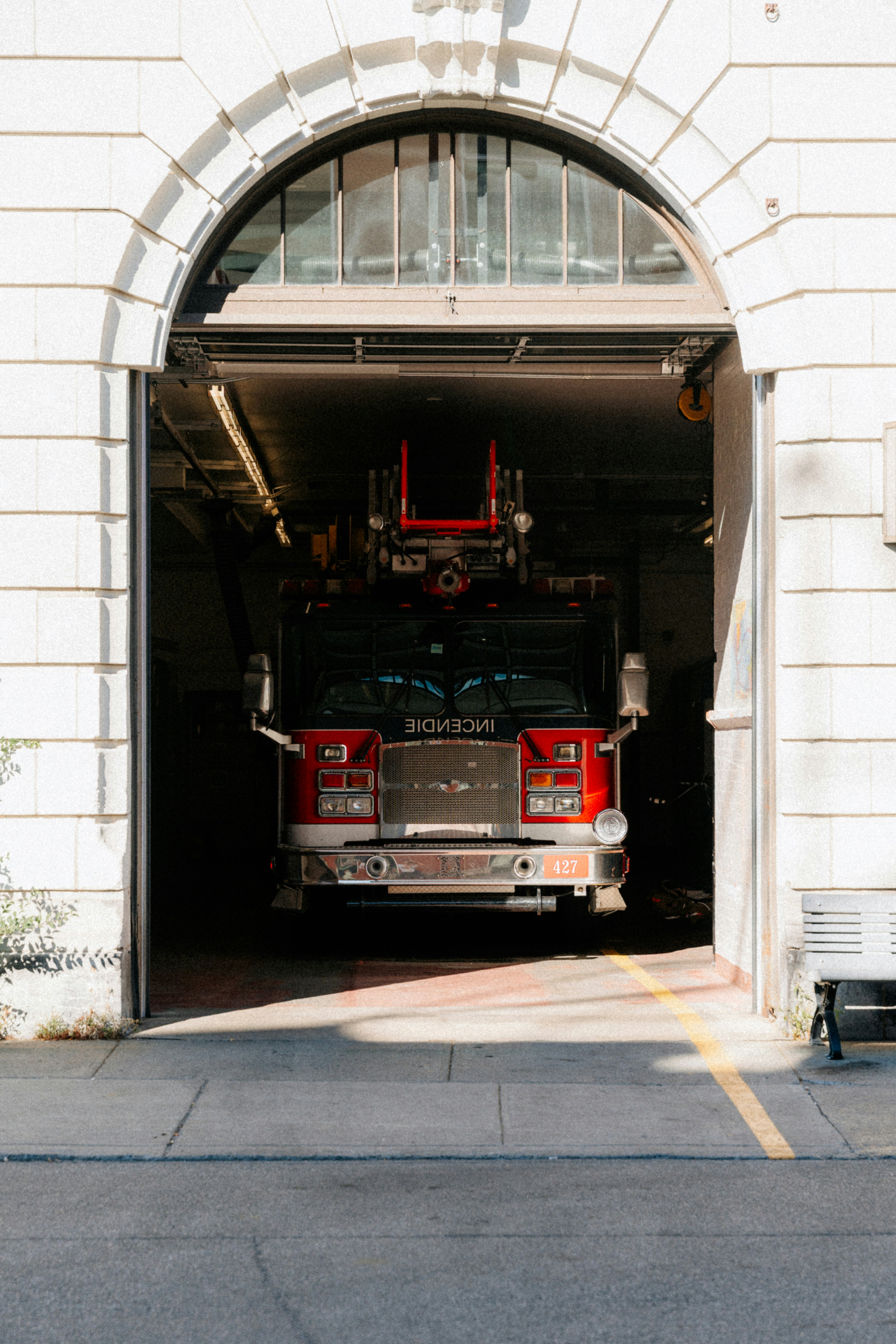 Red fire truck parked inside a station.