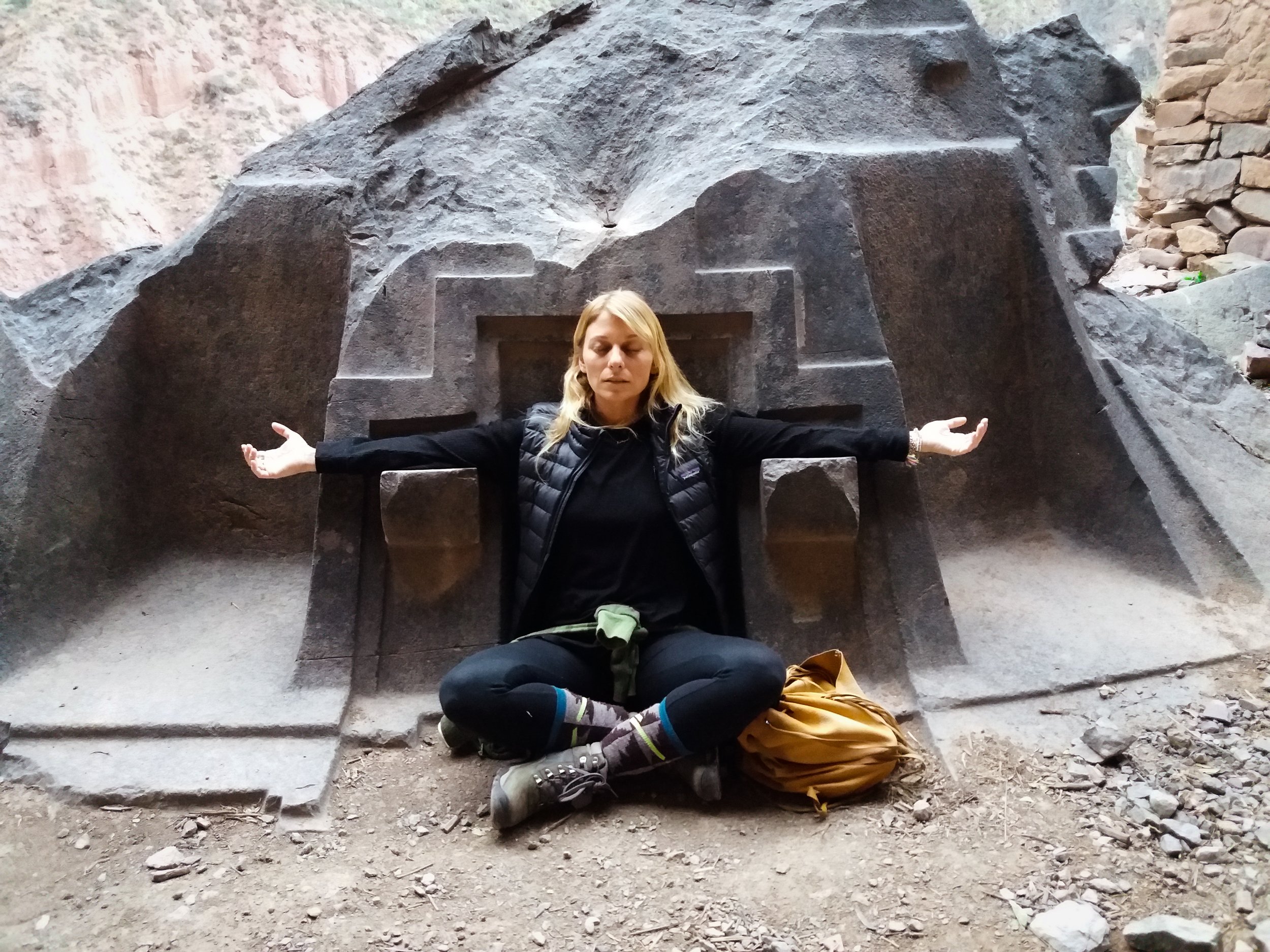 Serene depiction of a woman deep in meditation amidst an ancient peru site, harmoniously connecting past and present. Discover the timeless tranquility and spiritual energy of the sacred valley of peru