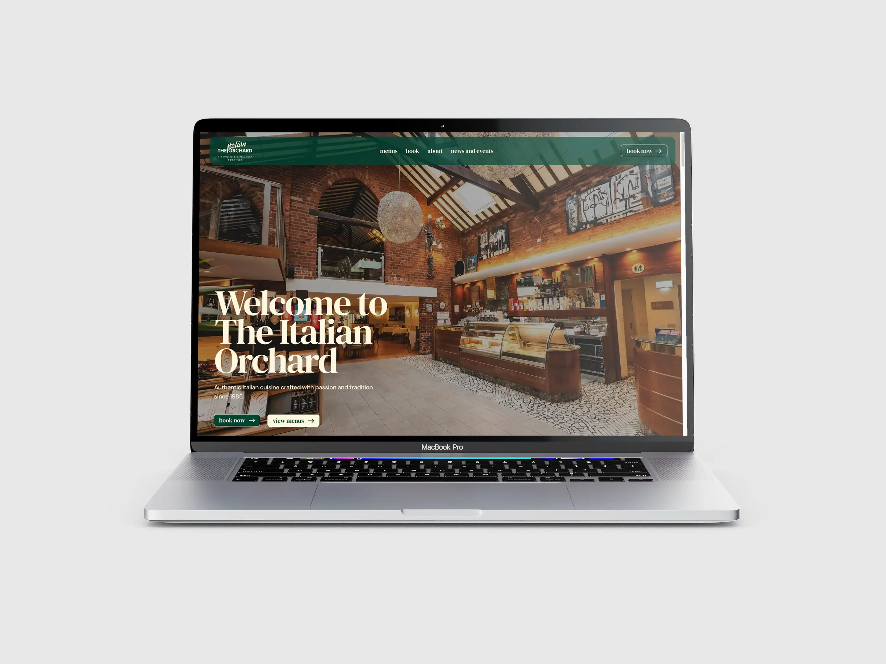 The Italian Orchard website displayed on a laptop, featuring its dining room and green navigation.