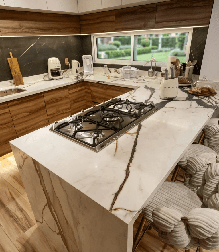 Modern living room with abstract art, beige sectional sofa, indoor plants, and large windows.