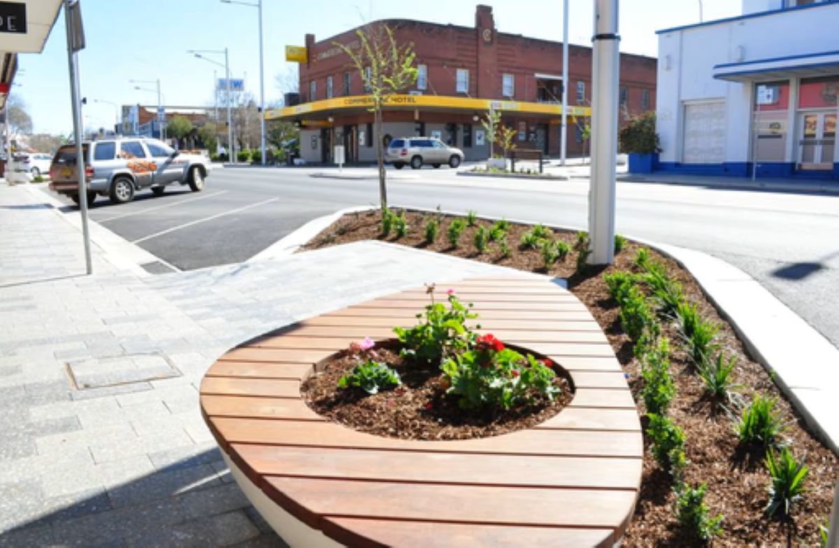 Urban streetscape improvements delivered by Uminex, featuring landscaped garden beds, integrated seating, pedestrian-friendly footpaths, and modern public infrastructure design.
