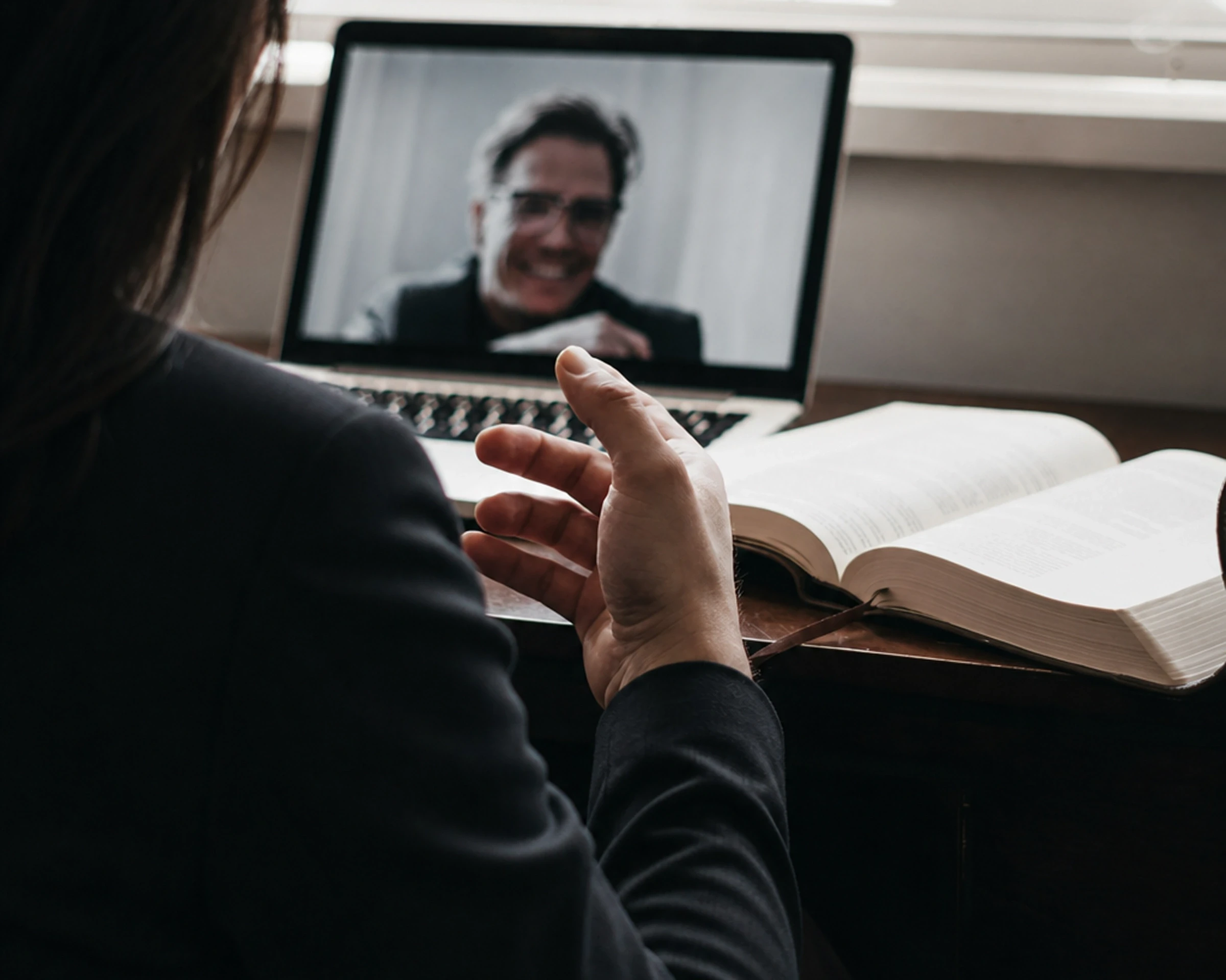 Adult patient speaking with a psychiatrist during a secure video appointment.