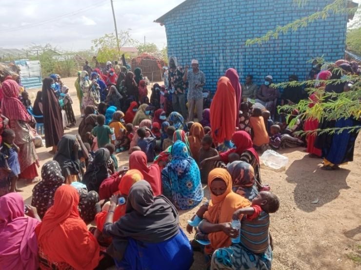 man in black crew neck t-shirt and blue shorts holding woman in white and red