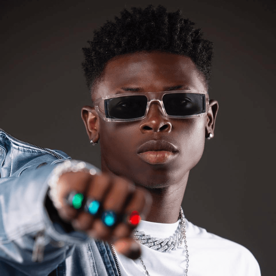 Man sitting against blue wall.