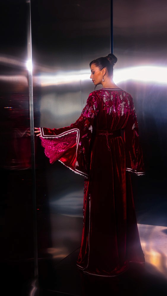 Fuchsia Moroccan caftan with sculptural sleeves and intricate embroidery, bold handcrafted couture piece in Bahrain