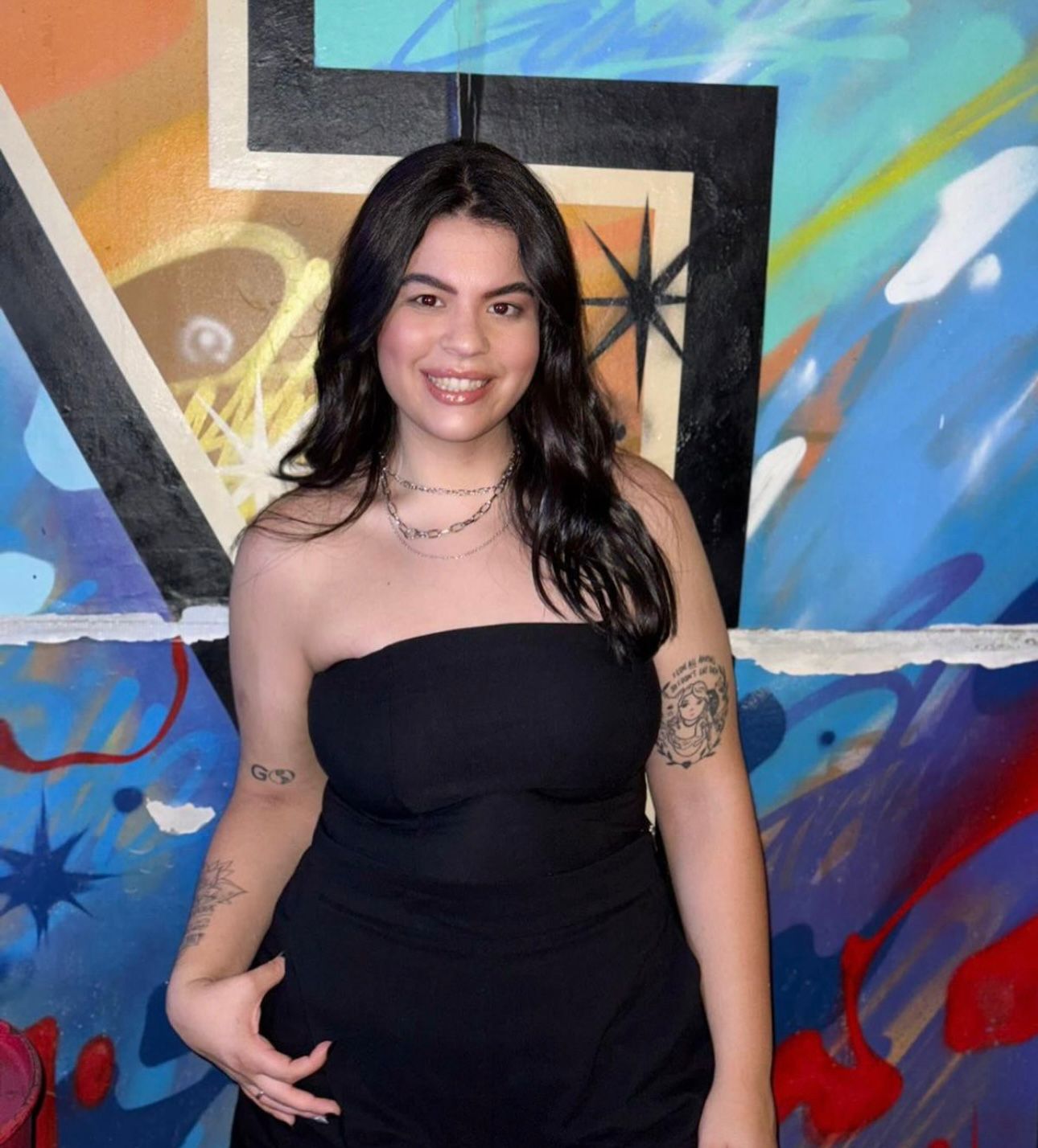 Sara is a client smiling to the camera happily