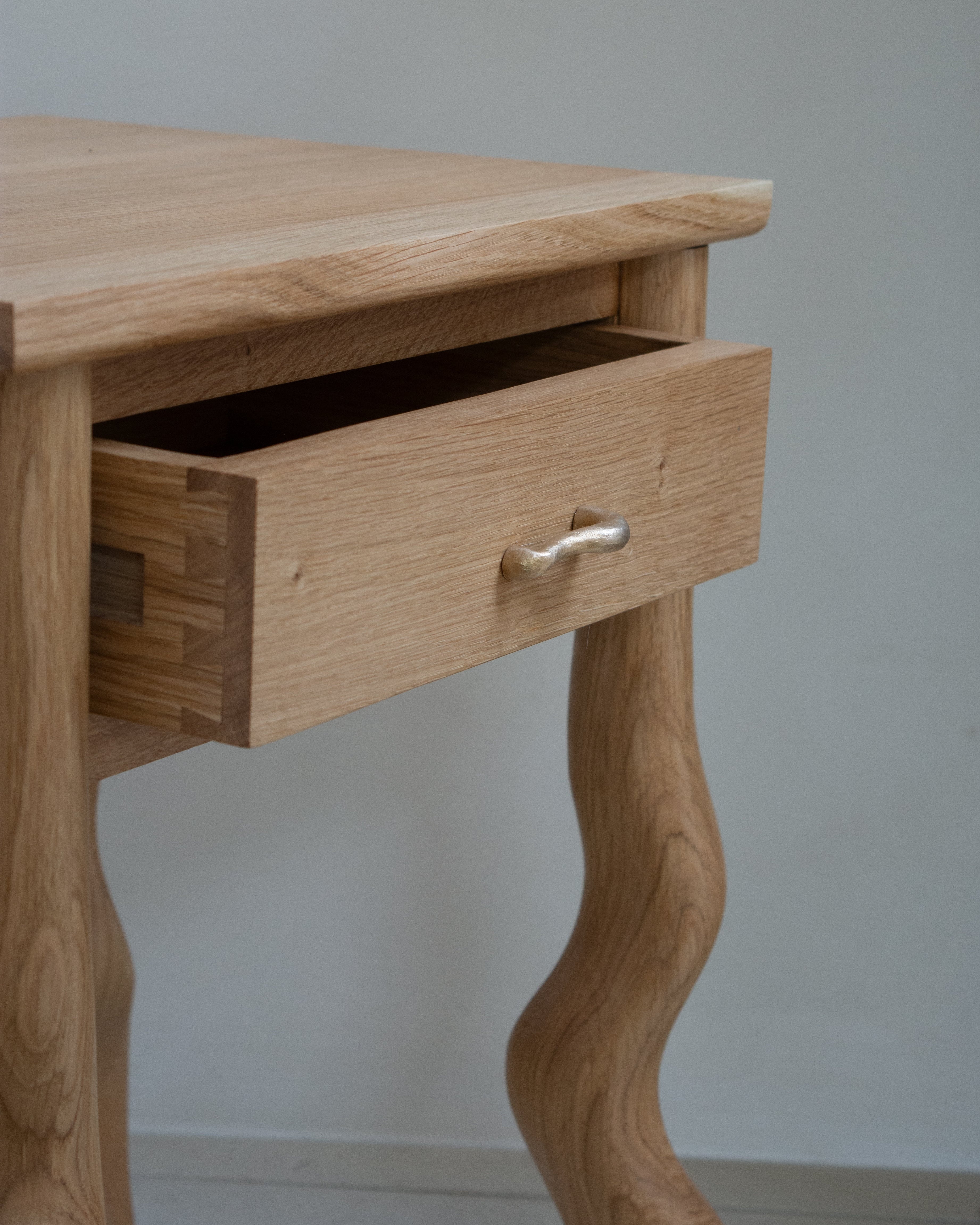 Wooden Dancing desk with a drawer against a plain background