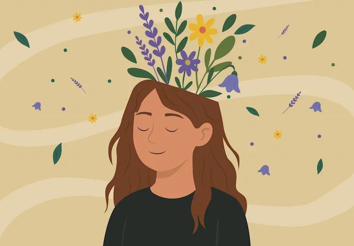 une femme souriante, avec des fleurs  au dessus de sa tête.
