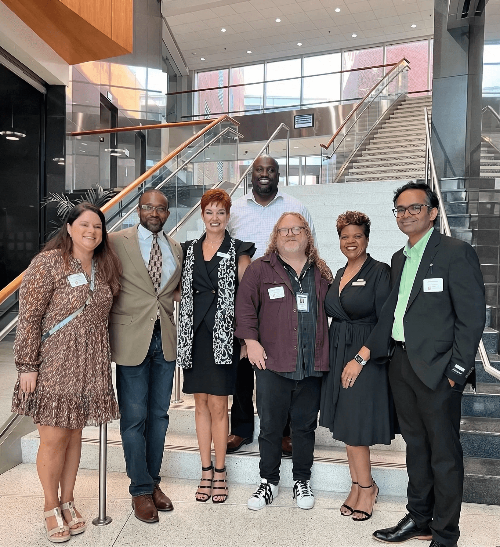 Portrait of a person in a pink sweater against a light background