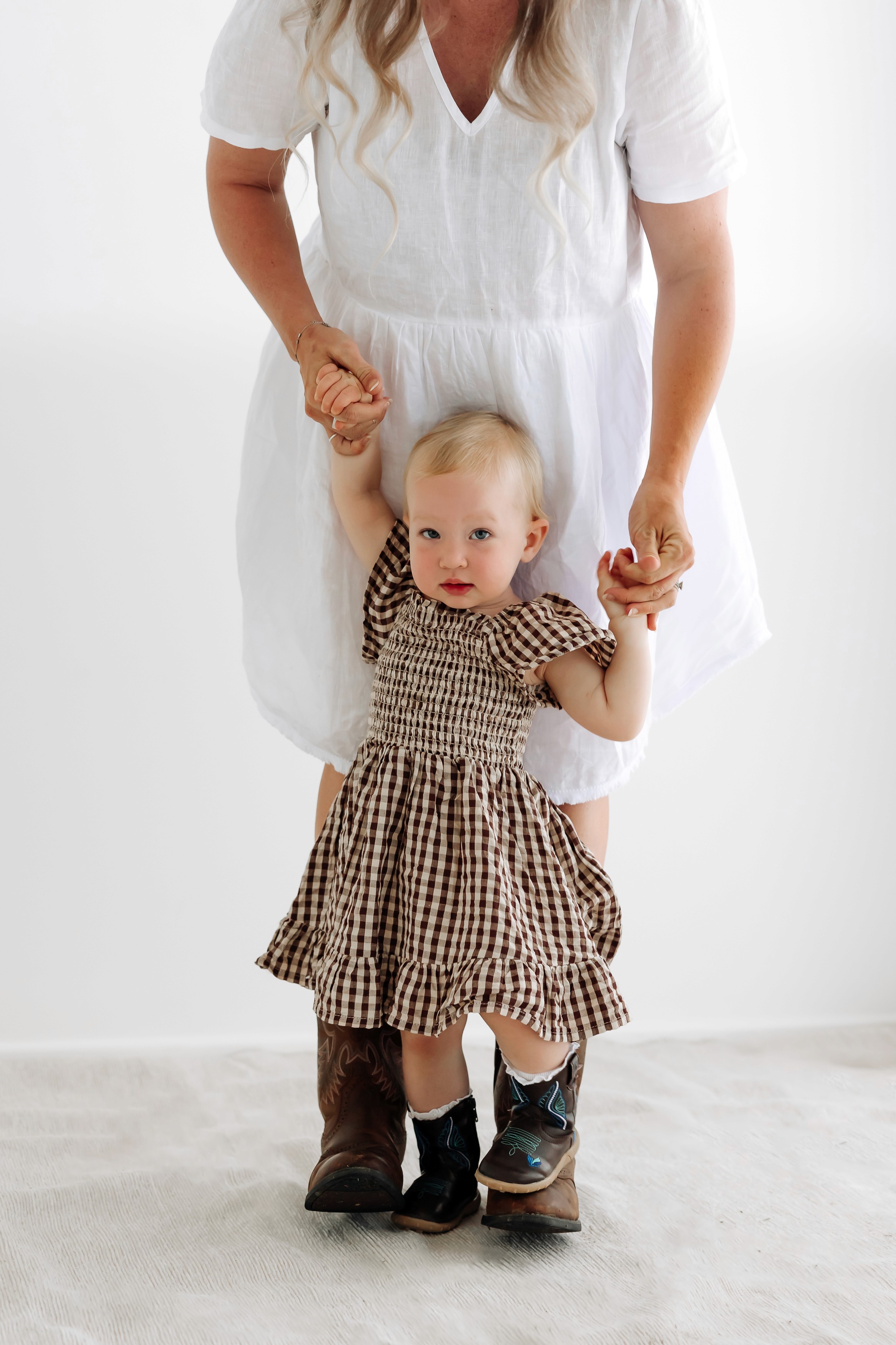 Mackay motherhood photographer capturing emotional studio portraits of a pregnant mother and daughter together