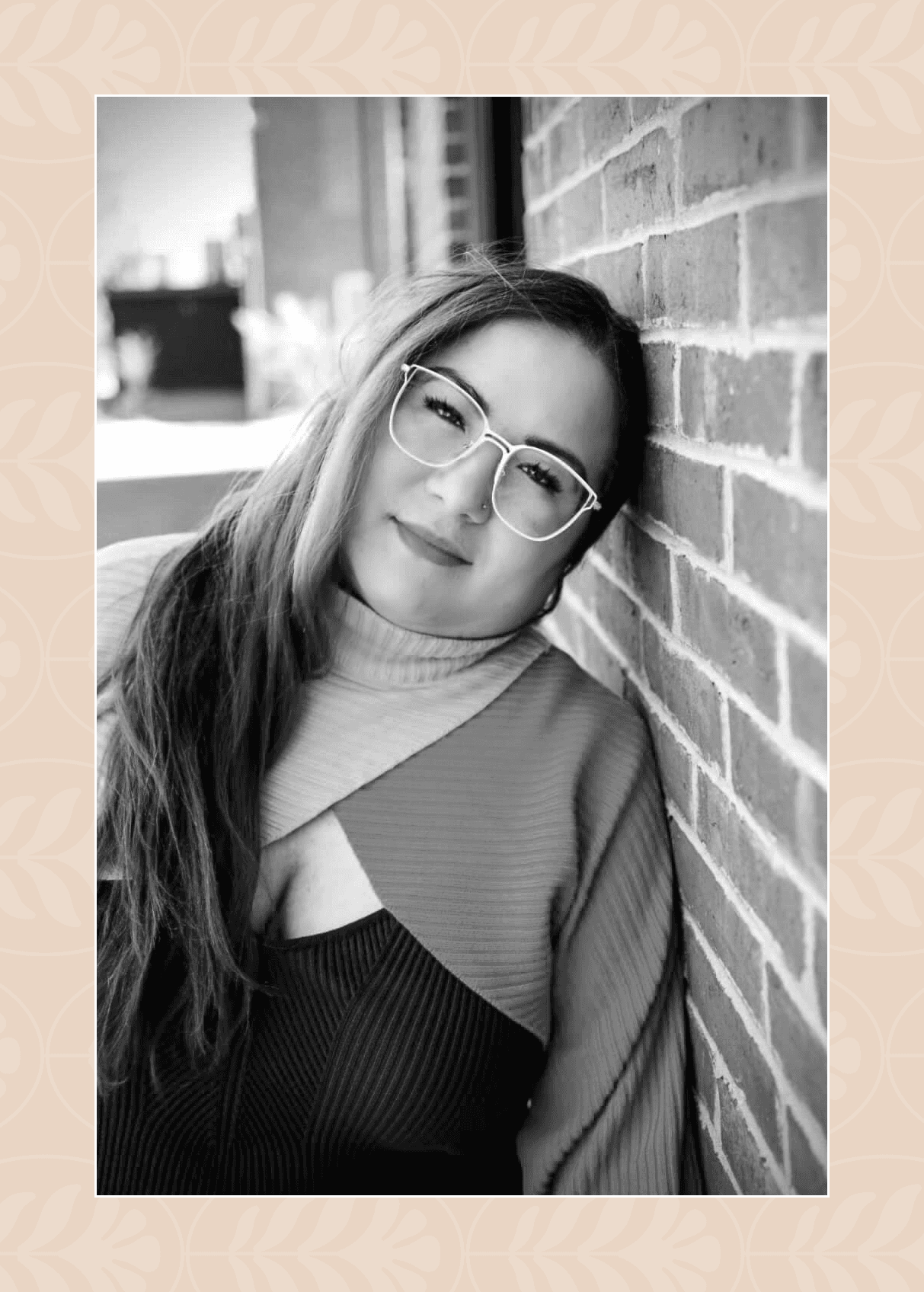 Glow Garden Studio founder Sonia, leaning against a brick wall