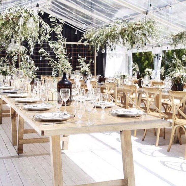 Airy Table settings under a clear roof marquee