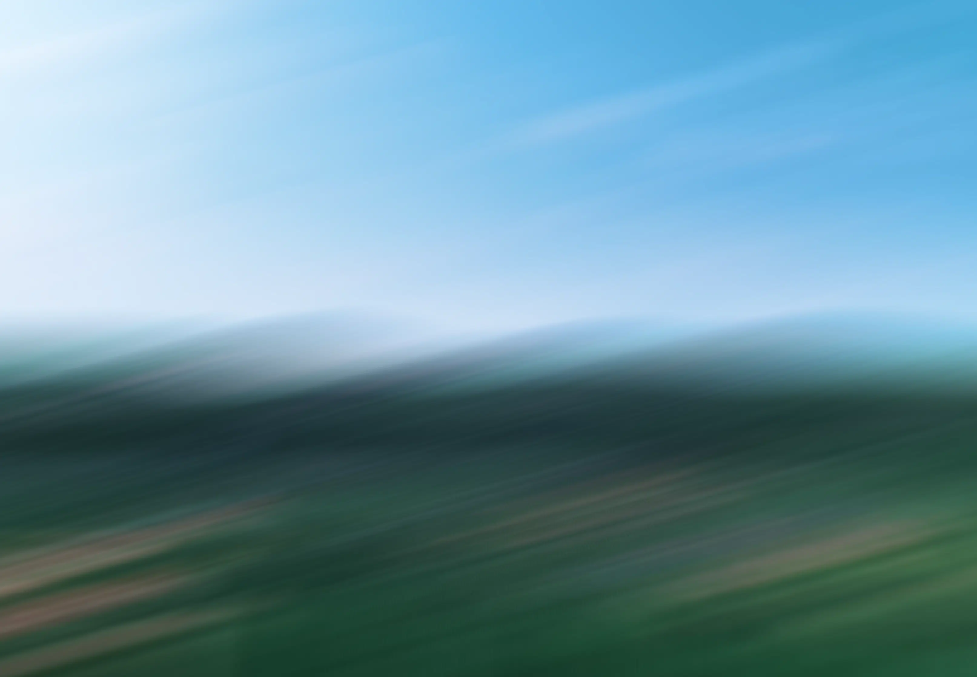 Green rolling hills landscape, motion blurred