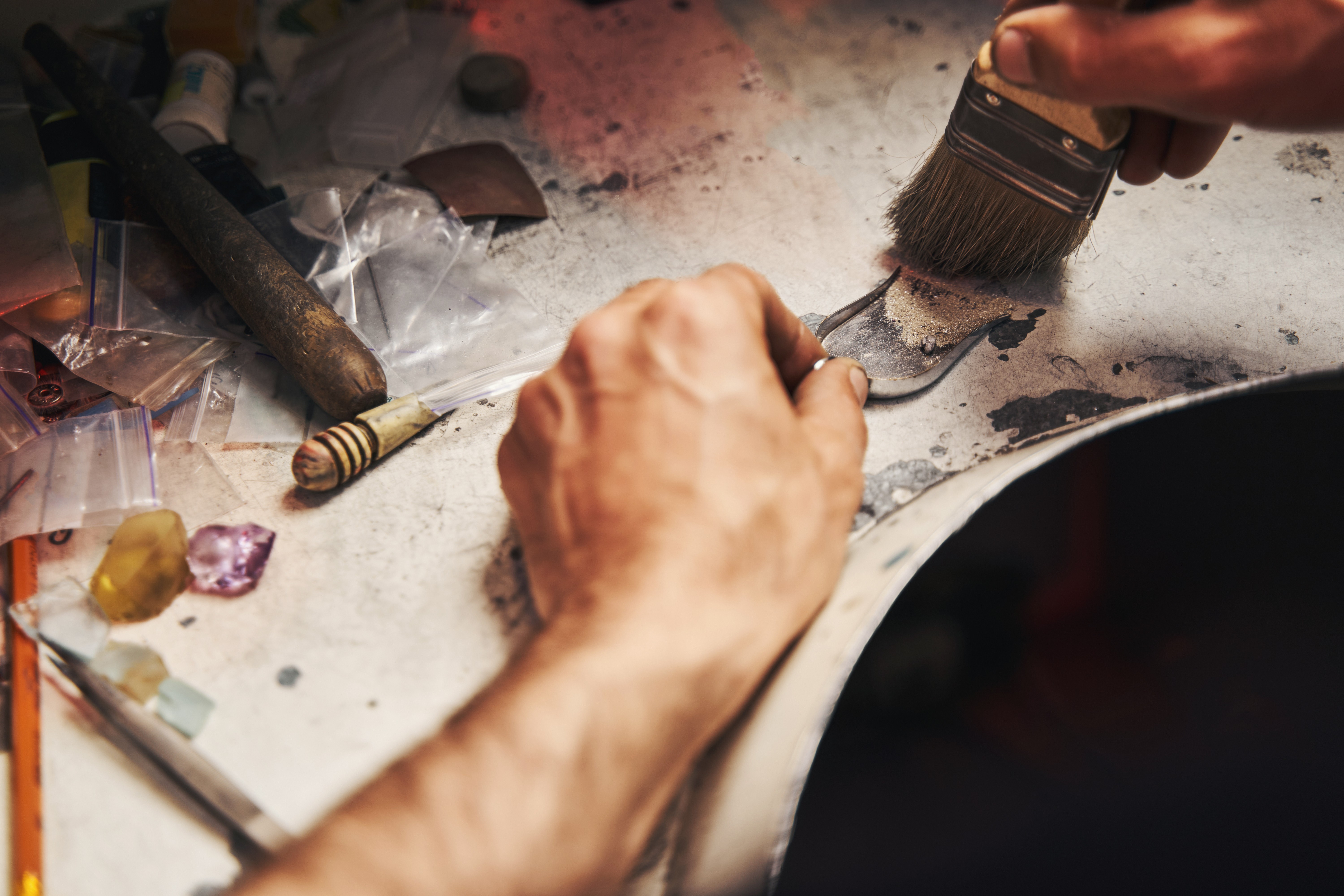 Gathering fine jeweler's dust and bench sweeps for precious metal refining.