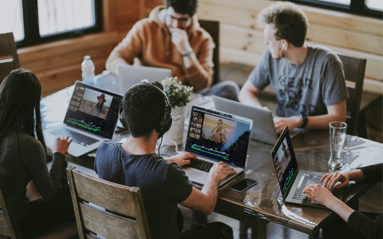 A group of students editing a video assignment collaboratively.