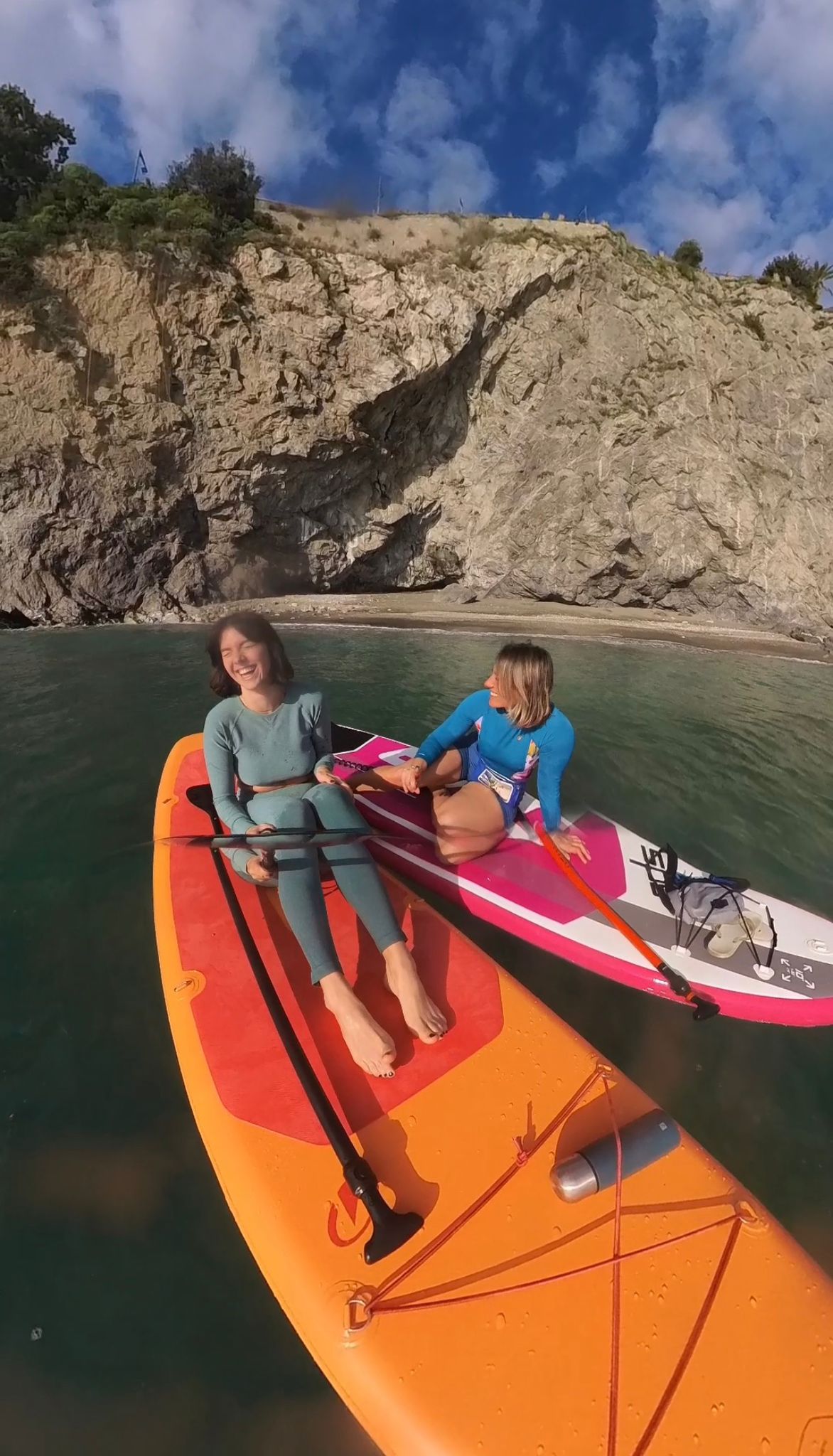 A man stading with Surfboard