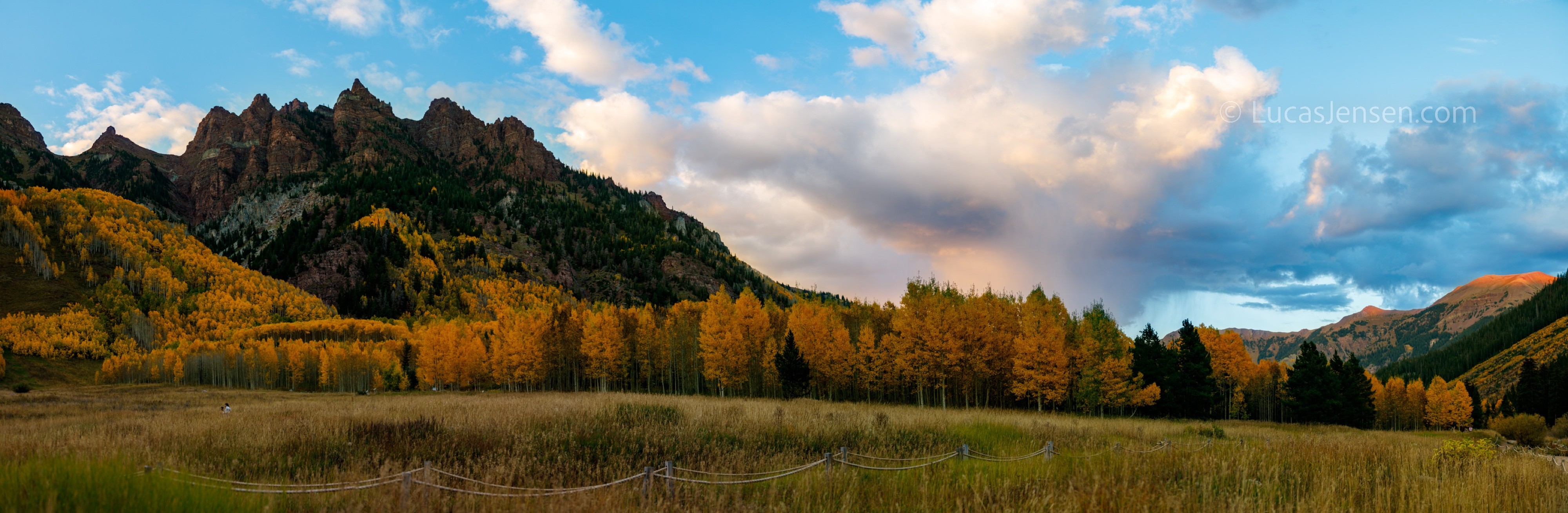 Panoramic landscape photograph of mountains, water, desert, or coast by Lucas Jensen