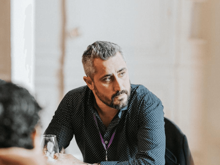 smiling woman wearing blue necklace