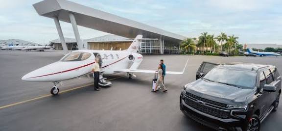 Vaunt private jet with travelers outside an airport terminal