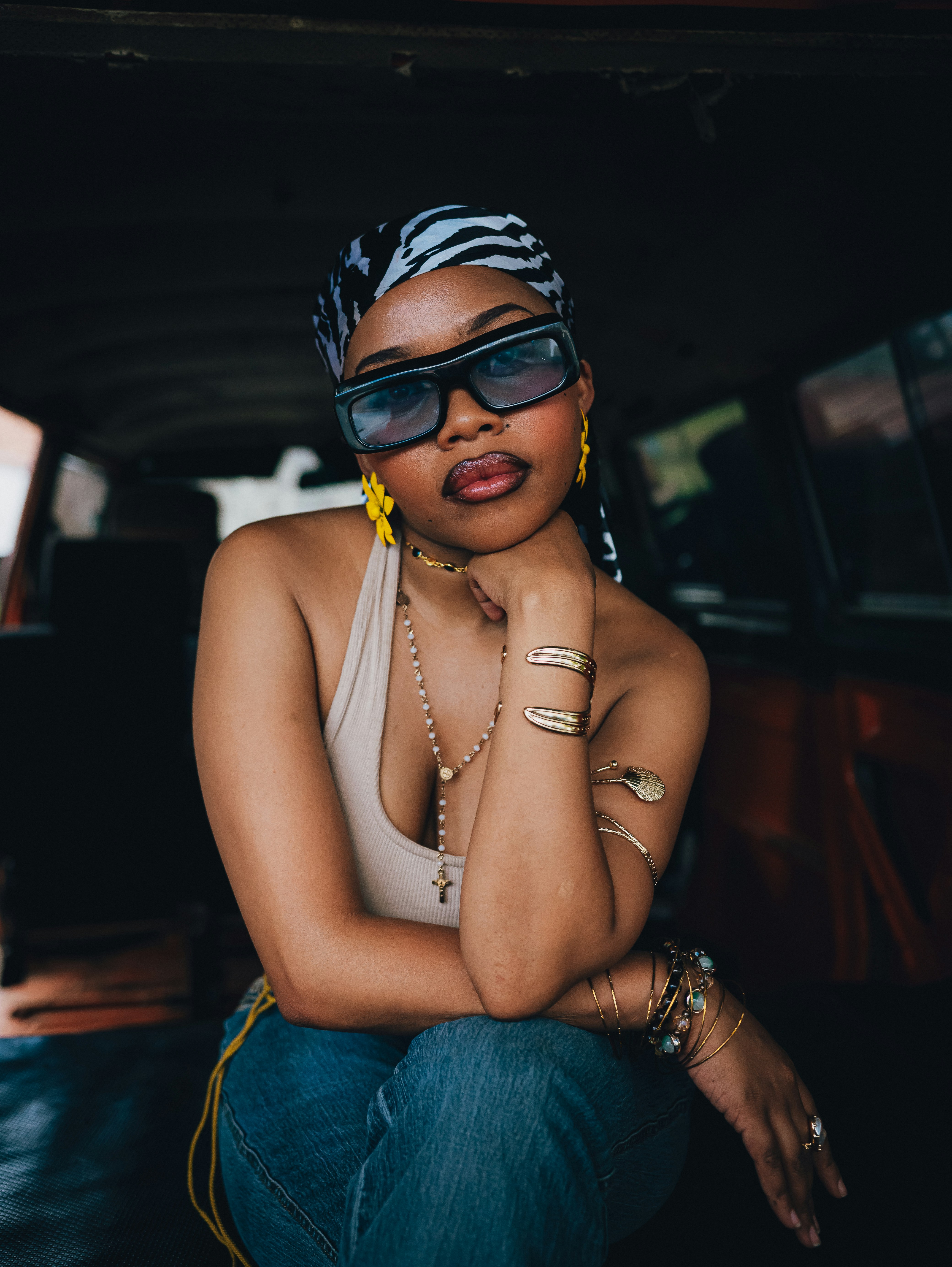 Woman wearing sunglasses and headscarf indoors
