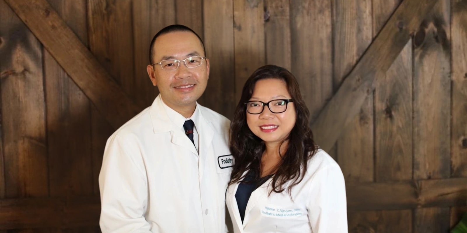 Helene T. Nguyen, DPM, and colleague in white coats, representing Feet 'N Beyond's commitment to advanced podiatric care.