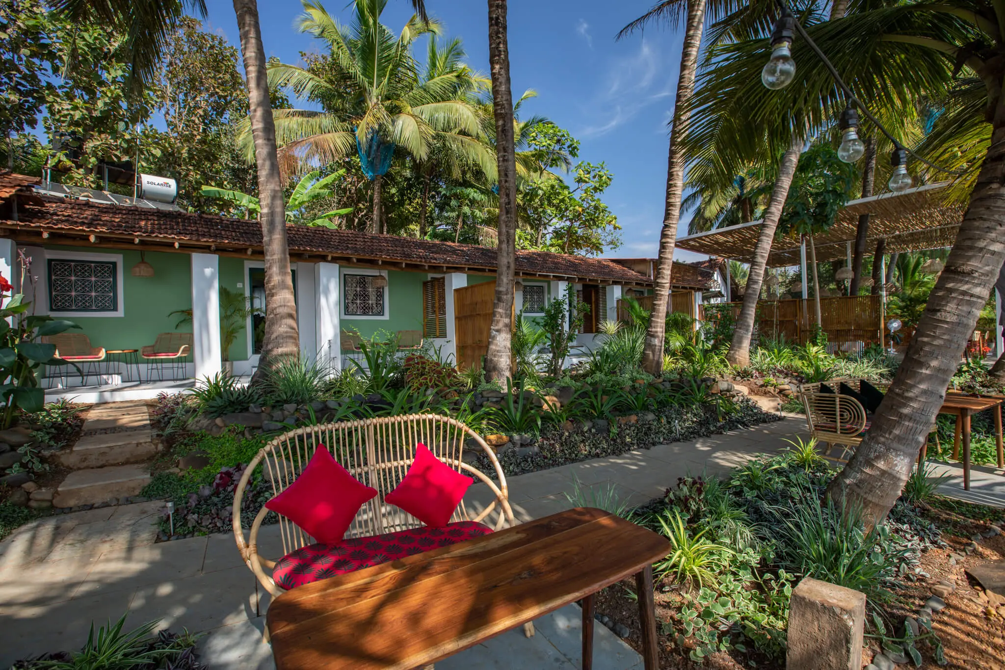 Sea View Family Room at Casa Jaali — garden bench outside the cottage