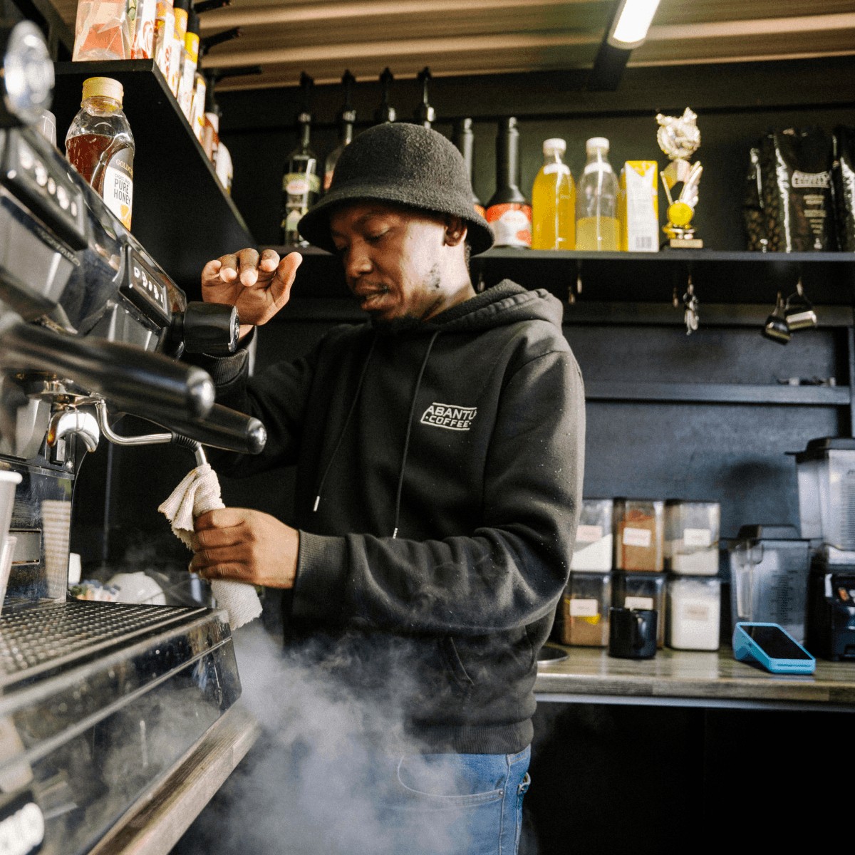A barista cleans an espresso machine