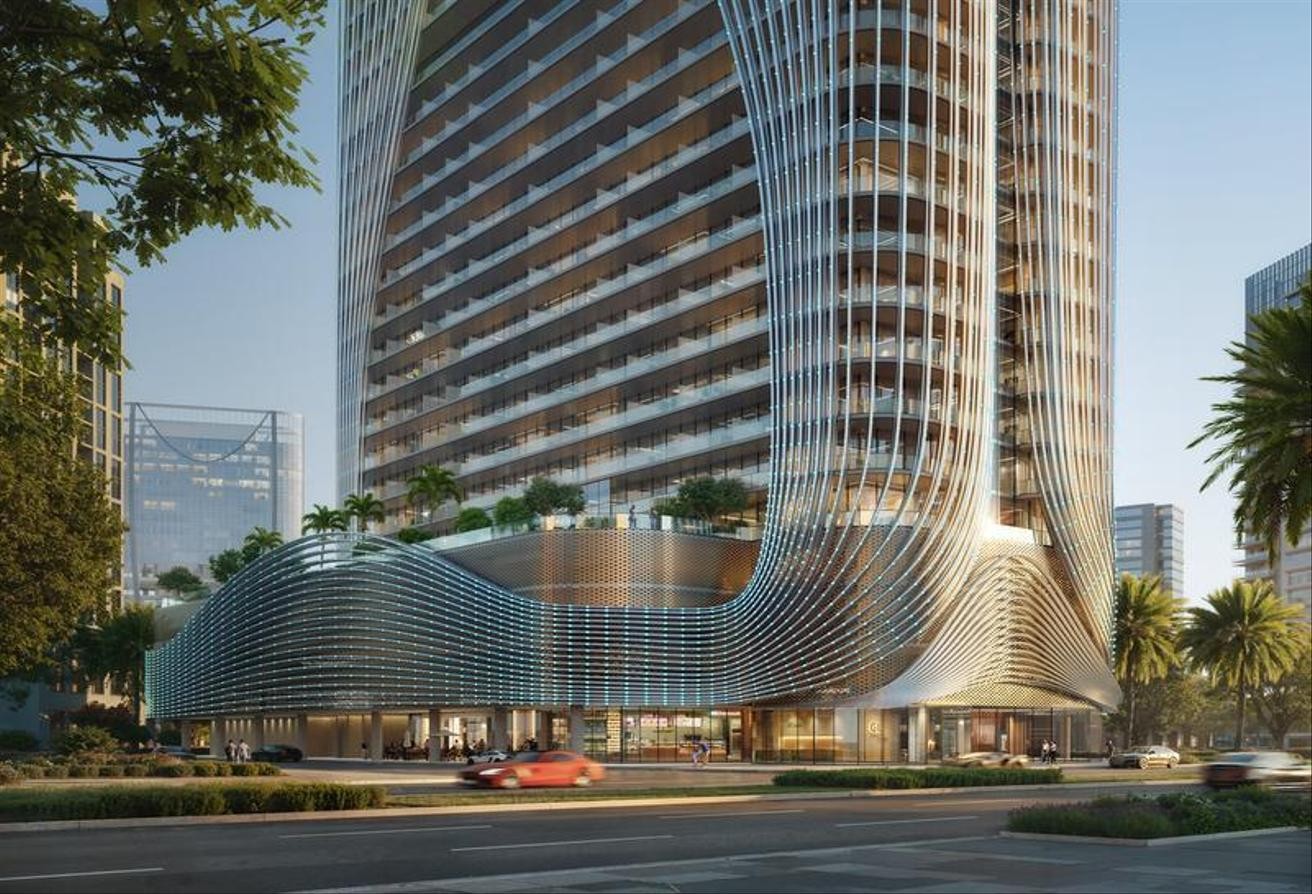 Exterior view of Binghatti Skyhall showcasing its futuristic architecture and flowing metallic facade in Dubai.