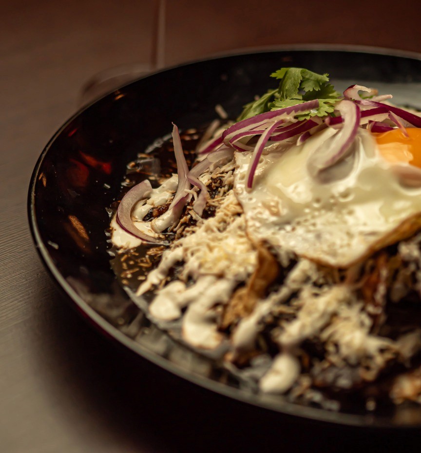 Chilaquiles verdes con huevo, crema y queso fresco en Piñata Cantina, el brunch mexicano más auténtico de Barcelona.
