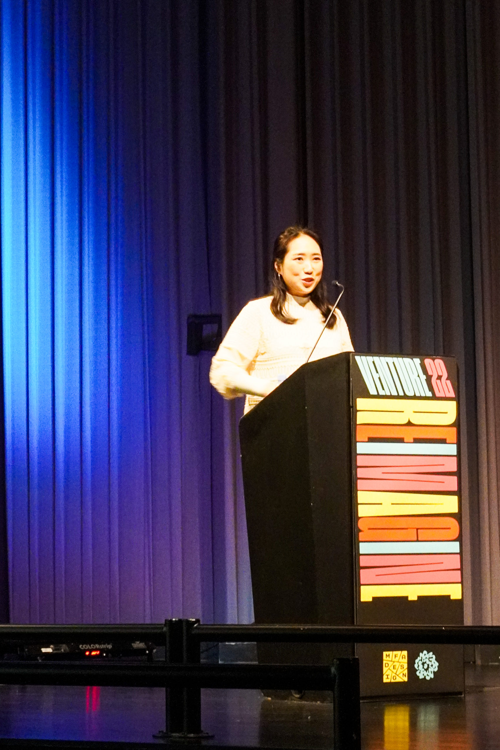 student presenting at podium for Venture Forum 22