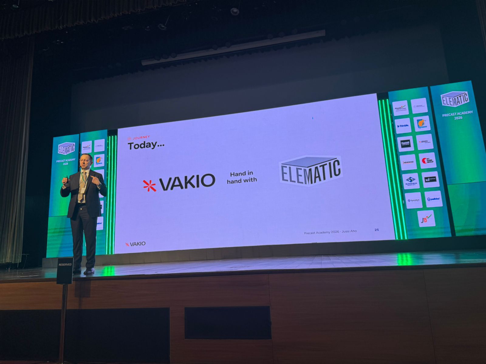 A picture of Jussi Aho on stage giving a speech.